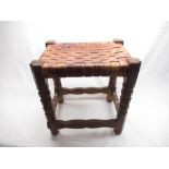 Robert Mouseman Thompson - oak stool with nailed plaited leather top on segmented octagonal legs