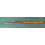 Native bamboo style wind instrument with inlaid detail and a brass top walking cane with internal
