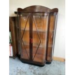 C. 1920's/30's bow front china cabinet enclosed by pair of plastic glazed door with plastic internal