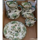 Graduated set of three Mason's chartreuse pattern hydra type jugs, three similar plates and a