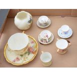 Royal Worcester cup and saucer decorated with spring flowers on a blush ivory ground with gilt