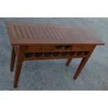 Contemporary side table with two drawers and slatted top with provision for ten bottles of wine on
