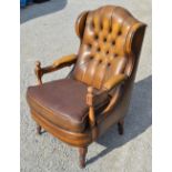 Leather upholstered open armchair, arched button wingback on turned supports, W65cm D70cm H110cm