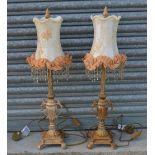 Pair of table lamps, low two handled bodies on stepped bases with scrolled feet, fringed shades.