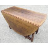 Titchmarsh & Goodwin oak gate leg dining table with two D shaped leaves and end drawer on baluster