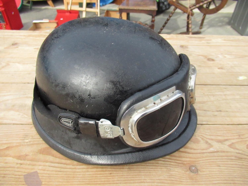 Black fibreglass military style helmet with associated goggles