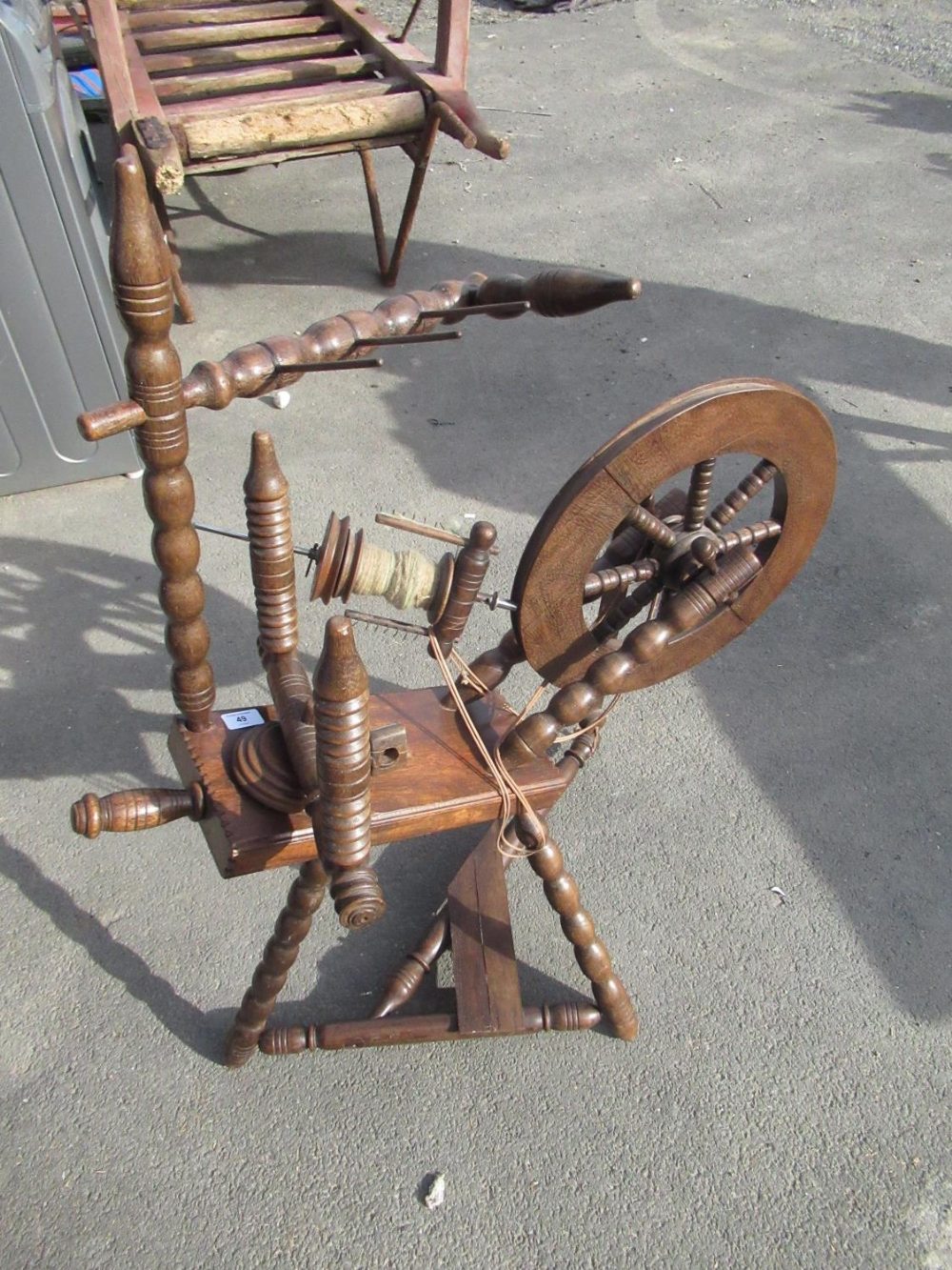 Victorian style oak spinning wheel on bobbin turned tripod base