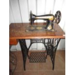 C20th Singer treadle operated sewing machine with black Japaned metal finish and Egyptian revival