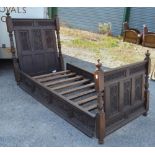 Pair of oak single beds, head & footboard with gothic & roundal carved panels, gothic carved side