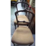 Set of four Victorian walnut salon chairs with arched scroll backs and stuffed over seats on slender
