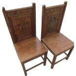 Pair of late Victorian oak hall chairs, solid backs with blind fret carved Gothic panels, solid