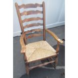Elm ladder back rush seated rocking armchair with forge made metal rockers