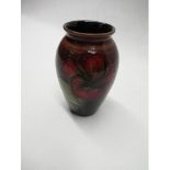 Moorcroft ovoid vase decorated in Hibiscus pattern on a red shaded ground, impressed marks and