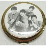 1960's The Beatles powder compact with central printed image of The Beatles in circular gilt case
