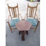 Pair of early C20th Arts and Crafts golden oak elbow chairs with pierced central splat scroll arms