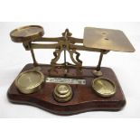 Early C20th lacquered brass postage scales on shaped moulded mahogany base, bearing ivorine