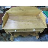 Pine wash stand, arched back above two drawers on pierced end supports joined by a solid stretcher