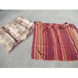 South American poncho, red ground with striped panels W117cm L129cm and a C20th string woven rug