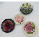 Three small Moorcroft circular dishes, D12cm, small Moorcroft saucer dish D9.5cm, all with various