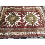 C20th Caucasian pattern wool rug, brown ground with two stylized geometric medallions and