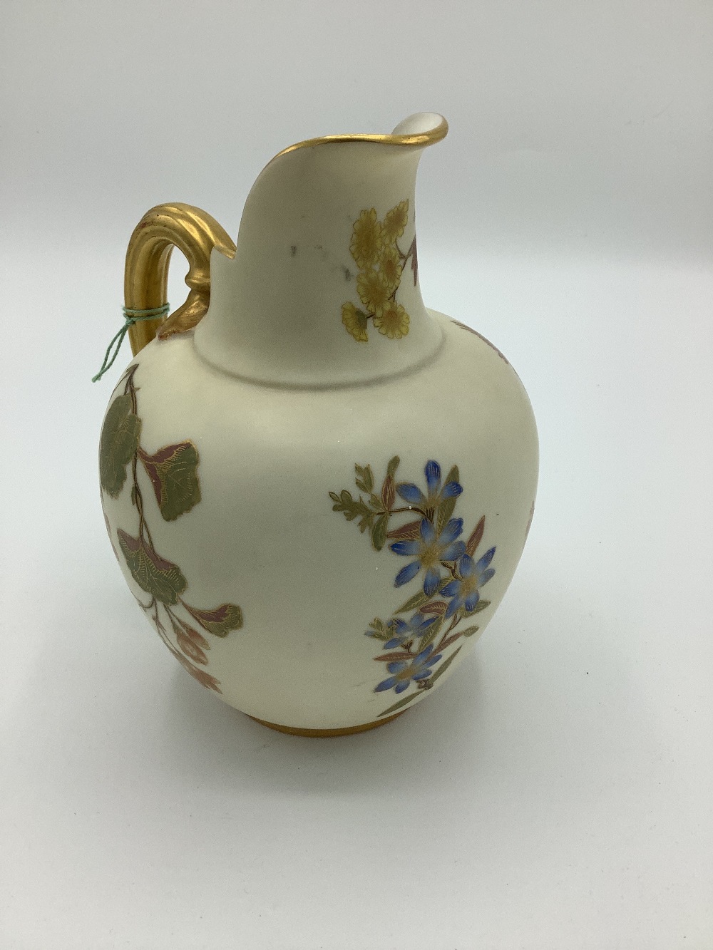 Late Victorian Royal Worcester jug, reeded gilt handle and blush ivory ground decorated with