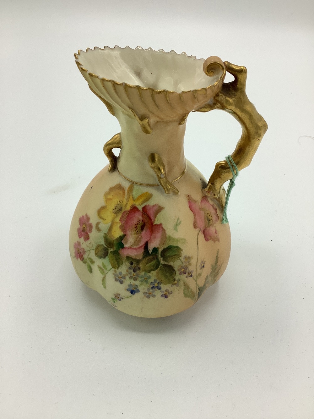 Early C20th Royal Worcester jug, coral handle and blush ivory ground decorated with roses with