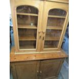 Victorian pine bookcase cupboard, moulded cornice and two arched doors above pair of panelled