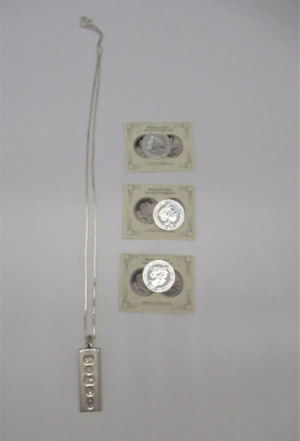 Three ERII Silver Sovereigns dated 2019 with COA (3) and a Sterling silver ingot charm L3.5cm