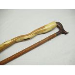 Pair of walking sticks, one twisted wood, one carved wood