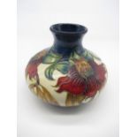 Moorcroft potter vase, squat body decorated with foliage on a cream ground, impressed marks and