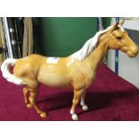 Beswick model of a palomino pony with a swish tail H21.5cm