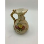 Early C20th Royal Worcester jug, coral handle and blush ivory ground decorated with floral sprays