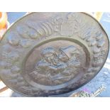 Metal charger plate depicting a man trying to kiss a woman, with Coat of Arms above the image