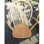 Ercol light elm rocking chair, arched stick back and broad arms