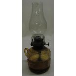 C20th gilt bed paraffin lamp with amber glass bowl and clear glass chimney H29cm