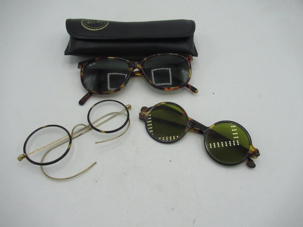 Tortoiseshell Ray Bans, pair of green lens sunglasses and another pair of spectacles