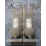 Pair of vintage style storm lanterns wall sconces, cylindrical glass shades on urn supports, H56cm