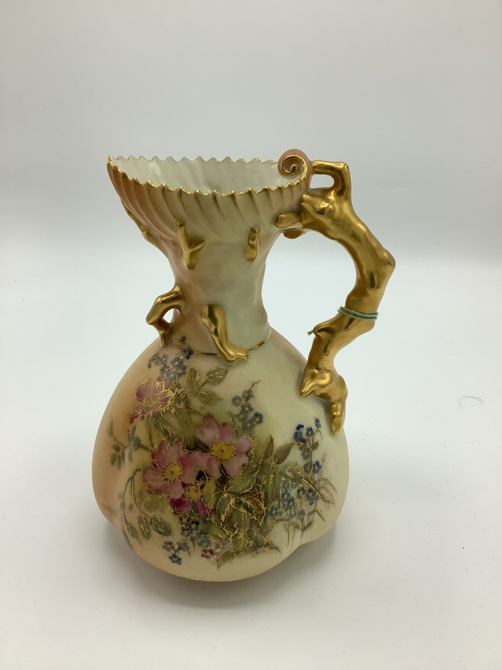 Early C20th Royal Worcester jug with coral handle, blush ivory ground decorated with floral