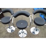 Set of three black faux leather and chromed bar stools