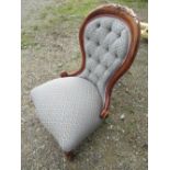 Late c20th Victorian style walnut framed nursing chair, floral carved decoration, deeply buttoned