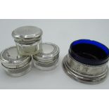Pair of Geo.V glass dressing table jars with bright cut silver lids, Birmingham 1911, another with