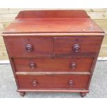 Early C20th stained pine chest of two short and two long drawers with turned handles, on turned