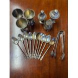 Collection of thirteen white metal Apostle tea spoons, set of white metal egg cups, EPNS barrel form
