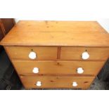 C20th pine chest of two short above two long drawers with white composition handles, W93cm D49cm