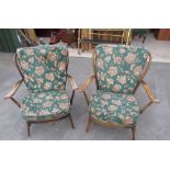 Pair of Ercol style dark wood open framed armchairs with stick backs and floral upholstered cushions