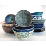 Collection of hand painted and glazed earthenware bowls and plates
