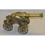 Early C20th brass fireside cannon, 15" staged barrel on brass carriage and wheels