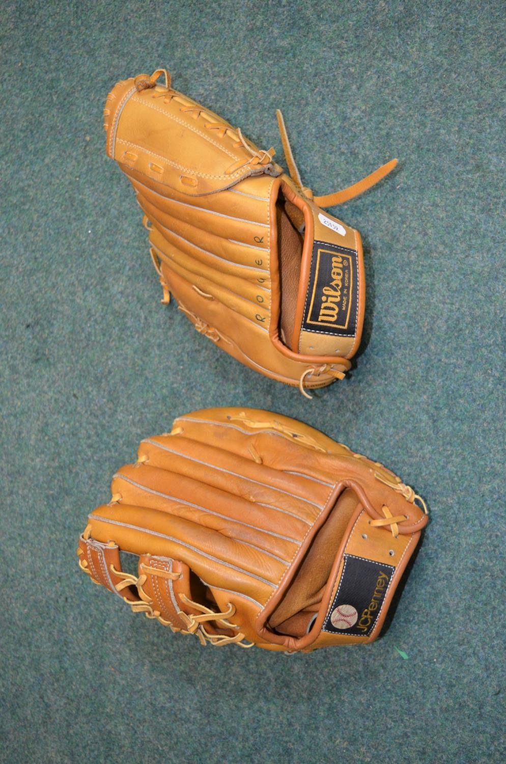 Two baseball gloves, one by JC Penny, one by Wilson