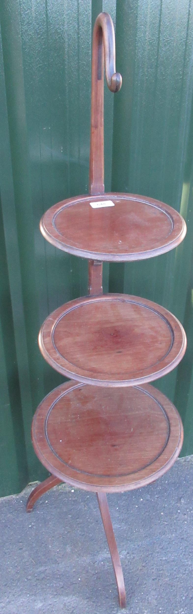 Early C20th mahogany cake stand with three graduated tiers on out splayed supports and shepherd's