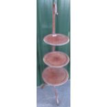 Early C20th mahogany cake stand with three graduated tiers on out splayed supports and shepherd's